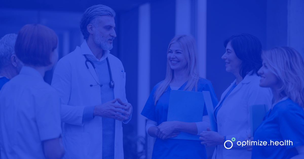 6 Doctors and Nurses Conferencing in Hallway with Blue Optimize Health Logo Overlay