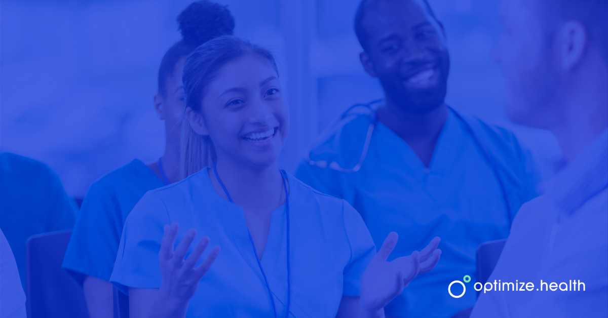 Nurse Smiling Answering Question Sitting in Front of Other Nurses with Blue Overlay and Optimize Health Logo